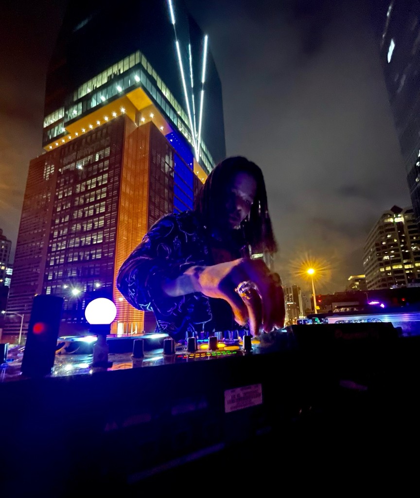 Juan Lo DJing outdoors at night